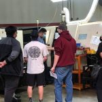 An Avanti team member demonstrating how a CNC machine is used.